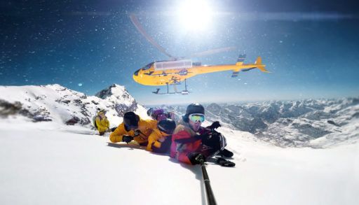 Snowboarders dropped off on a mountain for heli skiing
