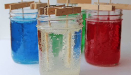 DIY rock candy project for kids forming in mason jars