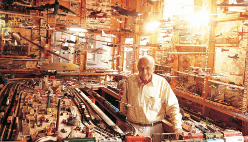 Ralph Silverstone, a cottager, stands in his museum of airplanes and trains