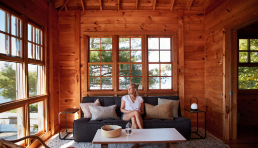 Artist Kara McIntosh sits inside the living room at her Georgian Bay cottage
