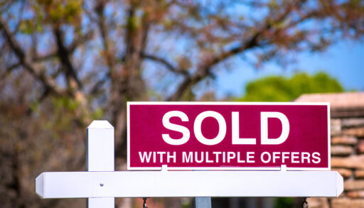 sold sign with a note that sold with multiple offers