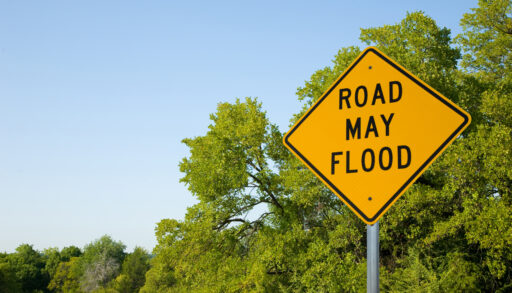 A yellow sign says "road may flood"