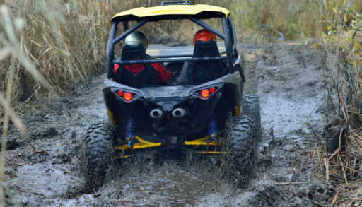 side-by-side, off-road vehicle going through mud